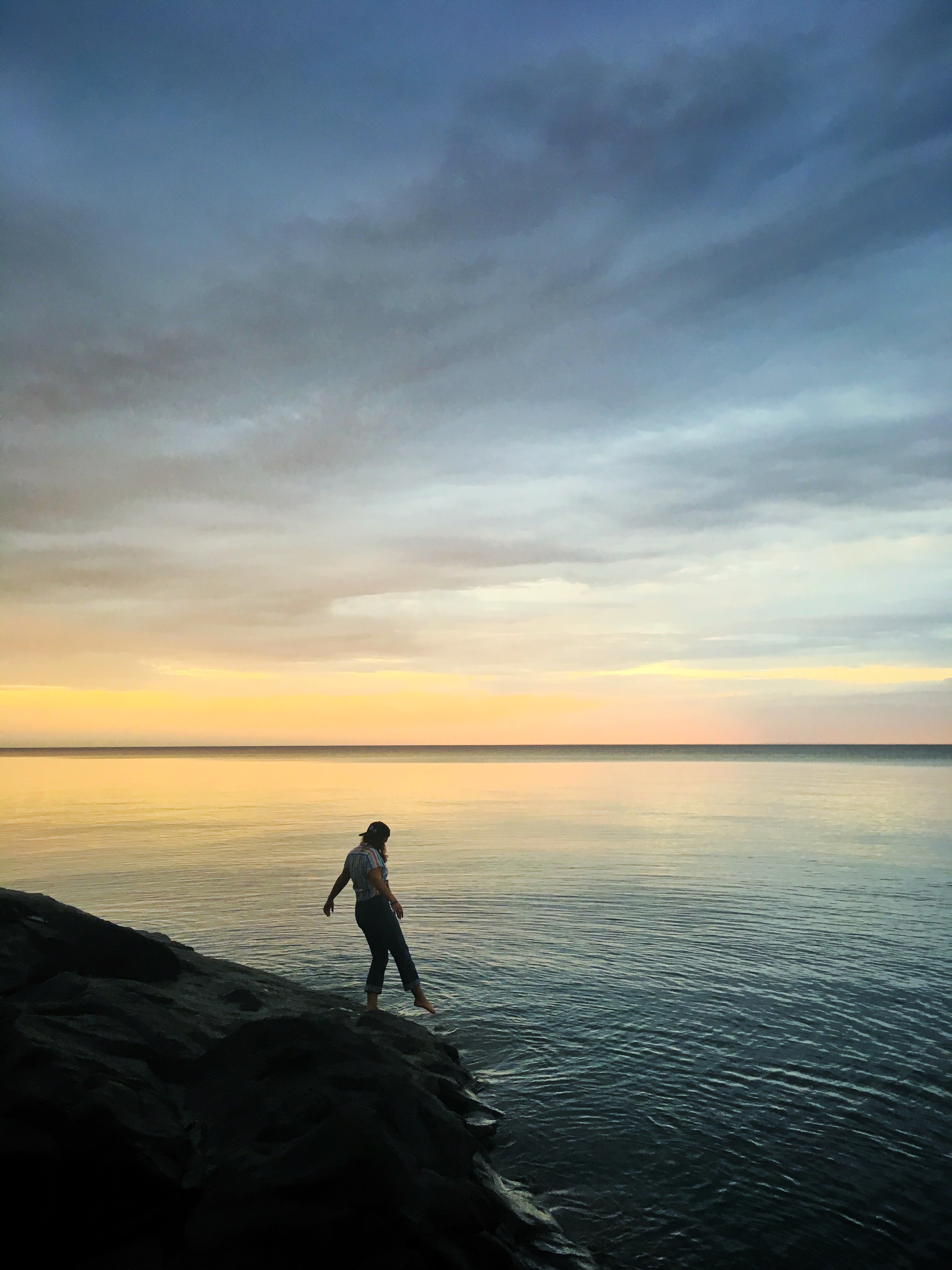 Woman dipping her toes in the water.