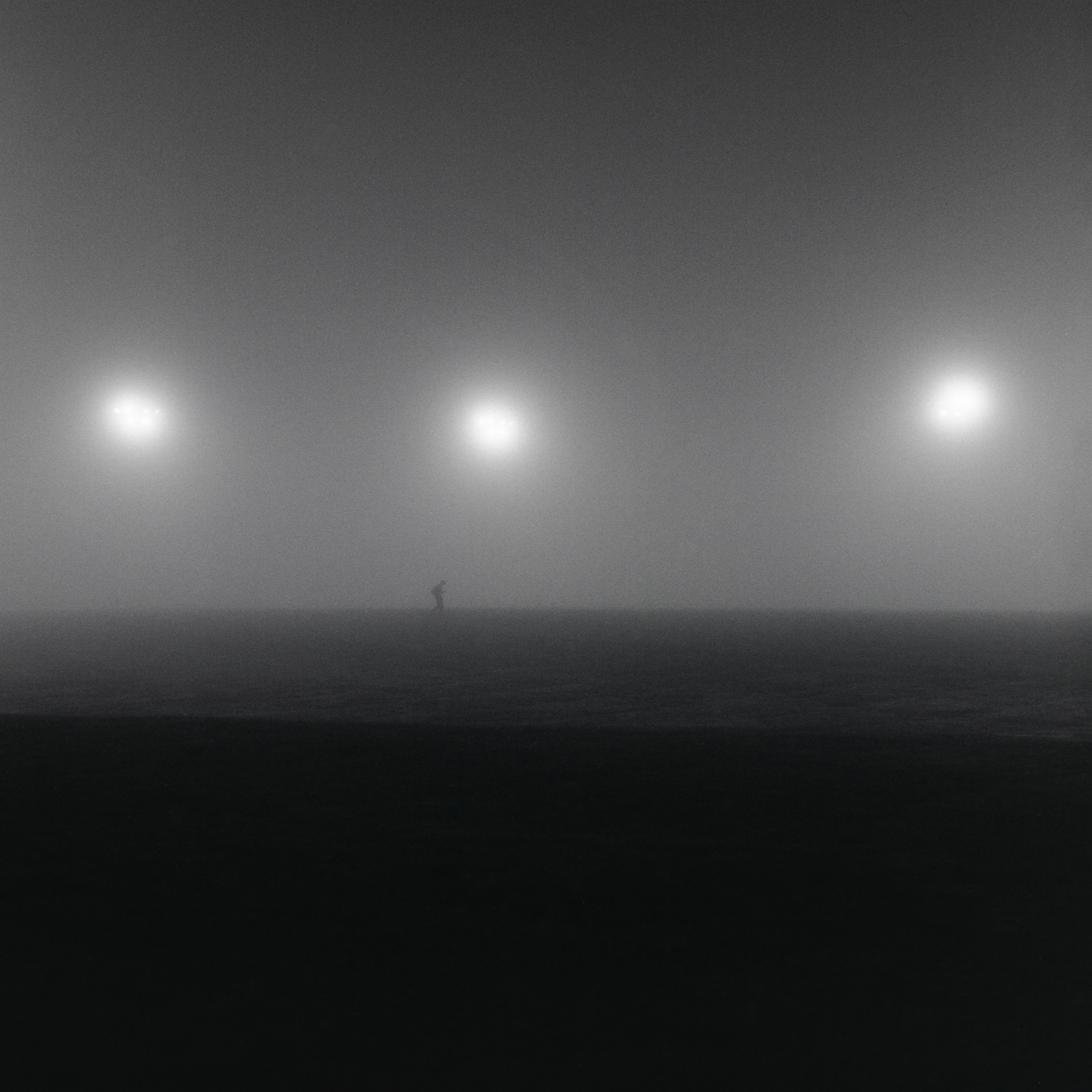 Person walking across a foggy field