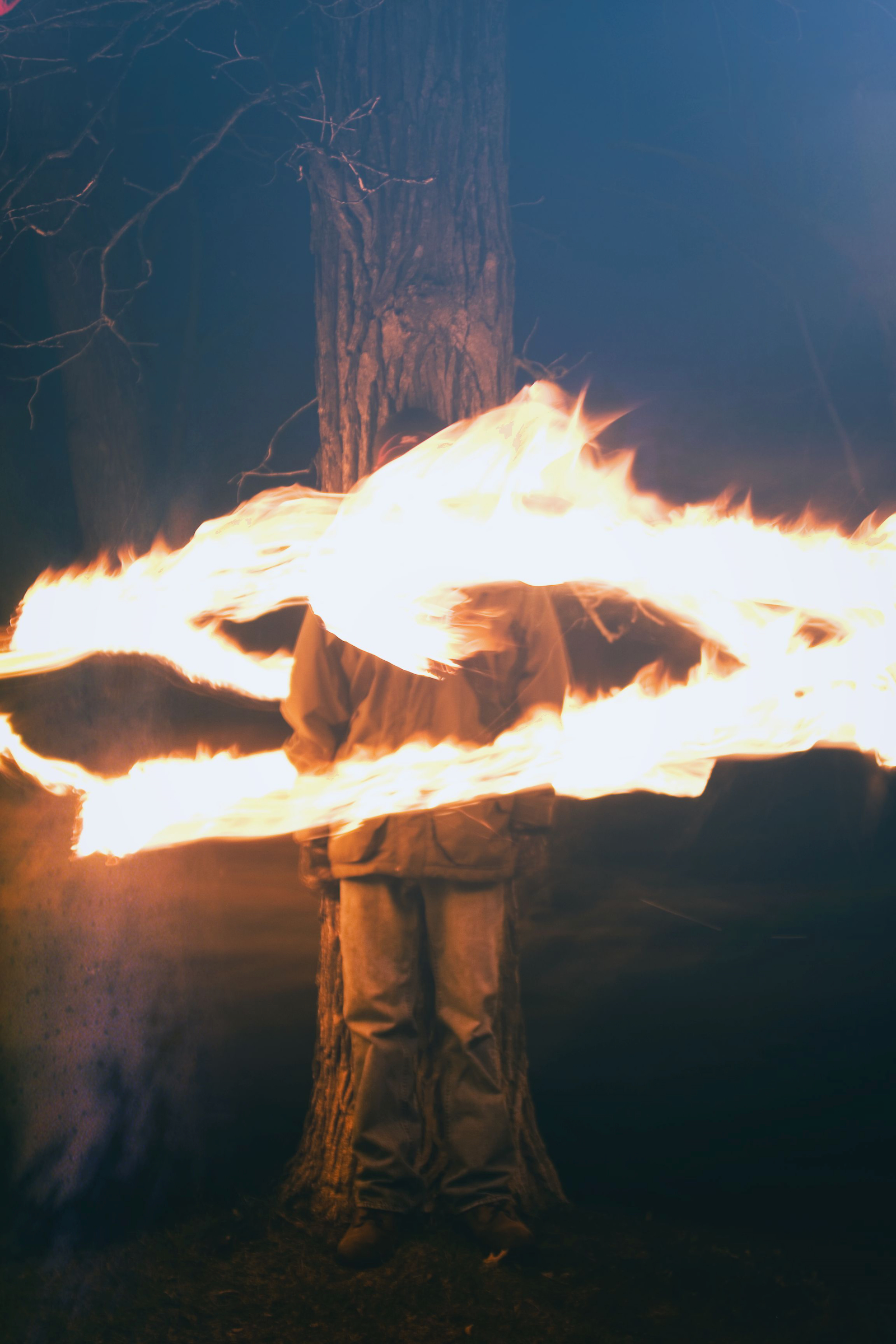 photo of person tied by fire